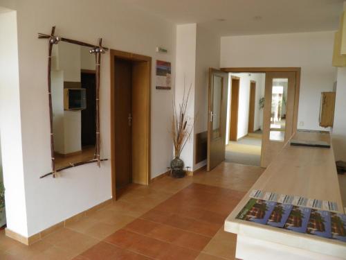 a living room with a mirror and a hallway at Pripetzite Hotel in Godlevo