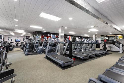a gym with rows of treadmills and elliptical machines at La Quinta Inn by Wyndham Binghamton - Johnson City in Johnson City