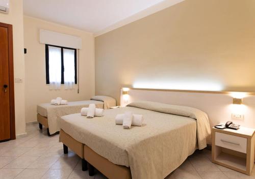 a hotel room with two beds and a window at Hotel Residence Nemo in Brindisi