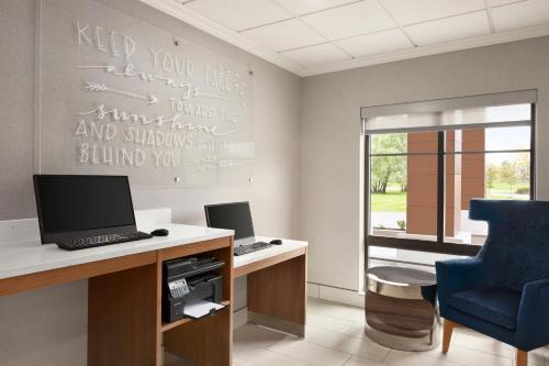 an office with a desk with a computer and a chair at La Quinta by Wyndham Lackawanna in Lackawanna