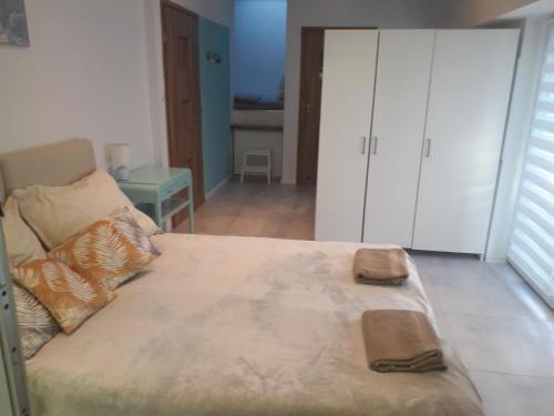a bedroom with a large bed and white cabinets at Sol De Sopot in Sopot