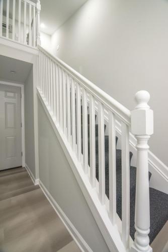 a white staircase with white railings in a house at The Georgetown House Inn in Washington
