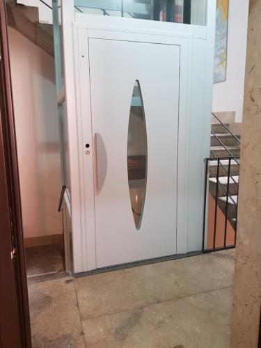 a surfboard sticking out of a white cabinet at La Trinacria Rooms in Trapani