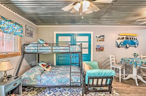a bedroom with two bunk beds and a table at Ocean Isle Beach Studio 1 Mi to Downtown and Pier in Ocean Isle Beach