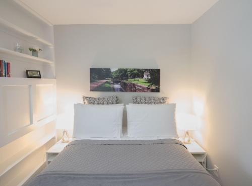 a bedroom with a bed with two white pillows at The Georgetown House Inn in Washington