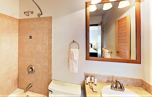 a bathroom with two sinks and a shower and a mirror at Pines at Meadow Ridge in Fraser