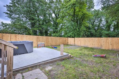 a backyard with a wooden fence and a yard with a stove at Home with Hot Tub Less Than 2 Mi to Downtown Richmond! in Richmond