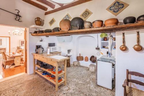 a kitchen with a counter with pots and pans on the wall at La Font - Vallem Properties in Pollença