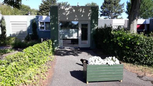 a cat sitting in a box in front of a house at Biesbosch Bed & Breakfast Werkendam in Werkendam
