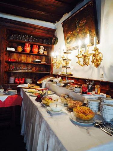 a buffet line with many plates of food on it at Bräugasthof Hallstatt in Hallstatt