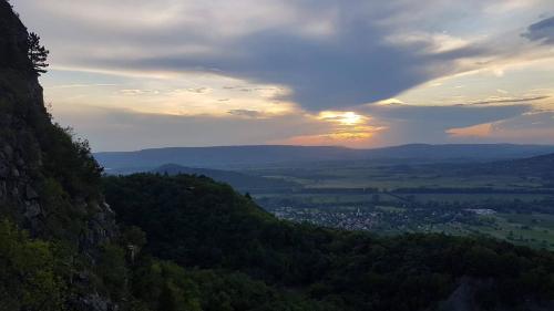a view of a valley with the sunset in the background at Szatmári Vendégház in Badacsonytomaj