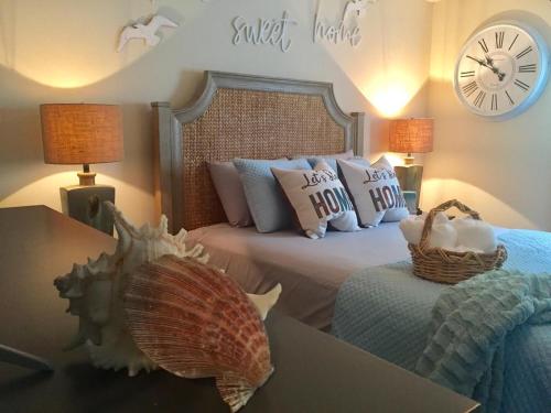 a bedroom with a bed and a clock on the wall at Southern Sophistication at Hickory in Ladson
