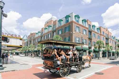 a group of people riding in a horse drawn carriage at Southern Sophistication at Hickory in Ladson