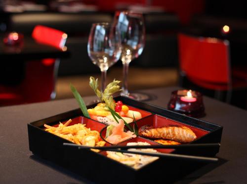 a tray of food on a table with wine glasses at Park Plaza Leeds in Leeds