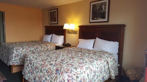 a hotel room with two beds and a telephone at Garden Inn and Extended Stay in Shepherdsville