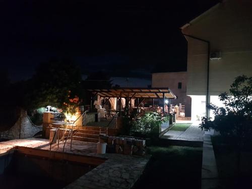 a night time view of a patio with a pavilion at VILA PEKEČ in Mala Moštanica