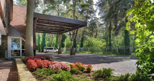 a pavilion with flowers in front of a building at Ukraina Hotel in Cherkasy
