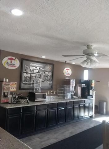 a kitchen with a counter and a ceiling fan at Super 8 by Wyndham Taos in Taos