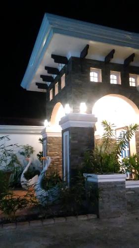 a house with a painting on the side of it at night at Venezia Suites Resort Panglao in Panglao Island