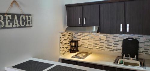 a kitchen with a counter top with a coffee maker at Palmeras Del Mar in Isabela