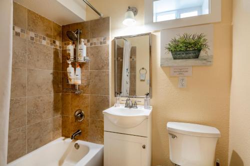 a bathroom with a toilet and a sink and a mirror at @ Marbella Lane 2BR Lower Level House in Downtown San Jose in San Jose