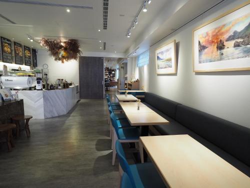 宜蘭市的住宿－行口文旅，一间设有长桌和蓝色长椅的餐厅