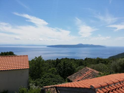 a view of the ocean from the roofs of houses at Holiday house Mavi -Obrs Moscenicka Draga,Riviera Opatija in Mošćenička Draga