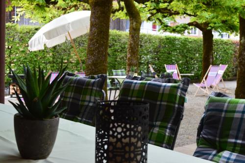 a group of green and blue pillows on a table at Hotel Garni Rösslipost in Unteriberg