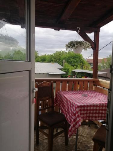 a table and chairs on a screened in porch with a view at vila elly in Piatra Neamţ