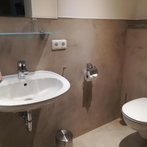 a bathroom with a sink and a toilet at Landhaus Irma in Bad Füssing