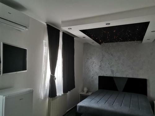 a bedroom with a bed and a window at Airport Apartments in Belgrade