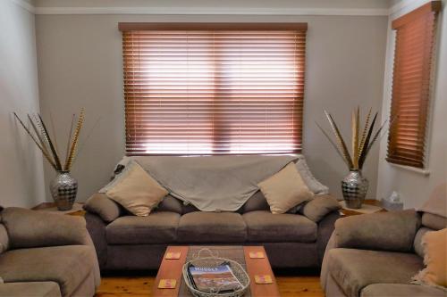 a living room with a couch and a table at A Market Place Mudgee in Mudgee