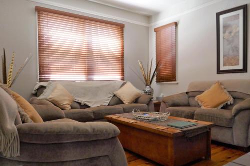 a living room with two couches and a coffee table at A Market Place Mudgee in Mudgee