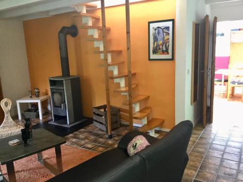a living room with a couch and a wood stove at Wohnidylle auf schönem Anwesen im Wald in Bad Honnef am Rhein