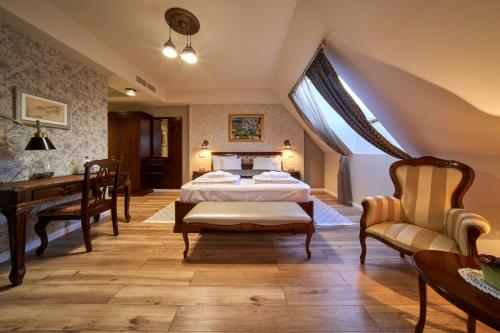 a bedroom with a bed and a desk at Takler Kúria in Szekszárd