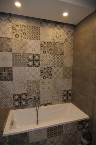 a bath tub with a faucet in a bathroom at Vácz Hotel in Vác