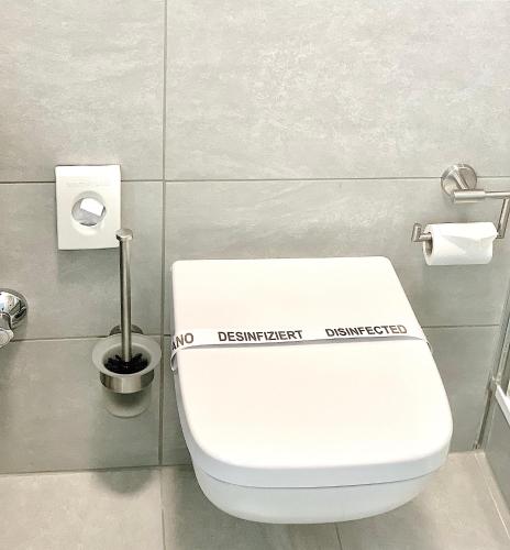 a bathroom with a white toilet in a stall at Hotel Carolinenhof in Berlin