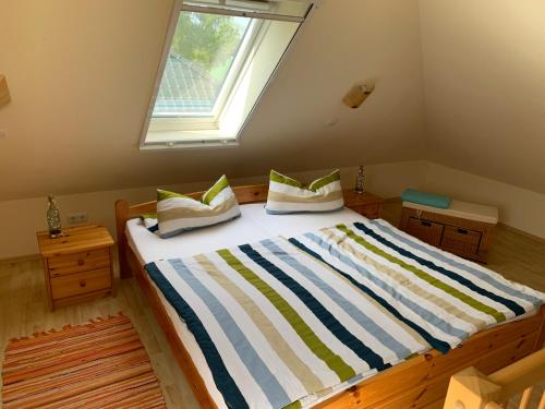 a large bed in a room with a window at Ferienhaus Elida in Krummin