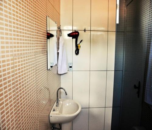 a bathroom with a sink and a mirror at Hotel Lago Conchal in Conchal