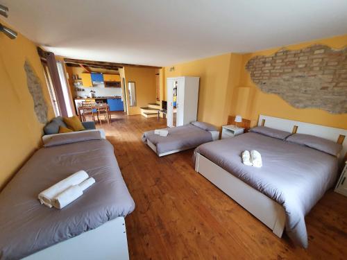 a room with two beds and a living room at I Balzani B&B in Matelica