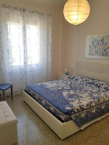 a bedroom with a bed with a blue comforter at Ca Enrico luxury flat in Monterosso al Mare