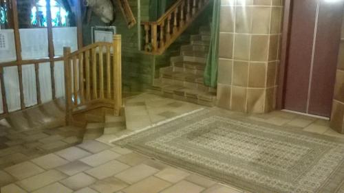 a hallway with a staircase and a rug on the floor at San Glorio in Llánaves de la Reina