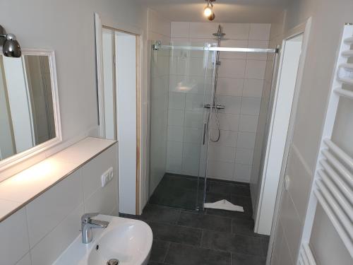 a bathroom with a shower and a toilet and a sink at Hotel Schleimünde in Kappeln