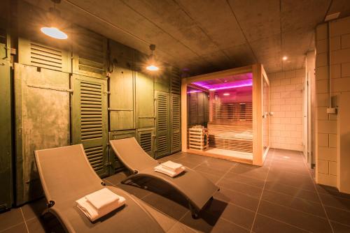 uma sala de spa com 2 cadeiras e uma janela em Independance Penthouse em Interlaken