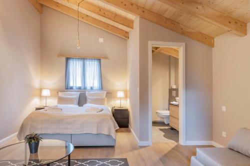 a bedroom with a king sized bed and a bathroom at Ahorn in Interlaken