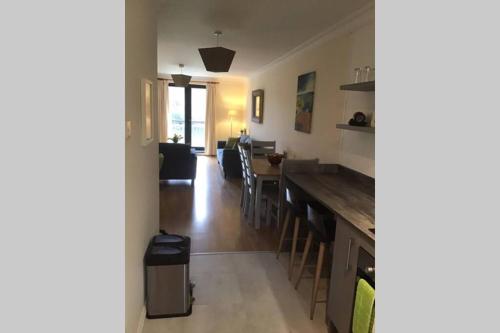 a kitchen and living room with a table and chairs at Waterfront apartment completely refurbished in Westport