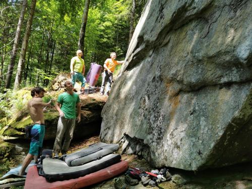 a group of people standing next to a large rock at POHORJE HOUSE 2 FOUR APPARTMETNS in Oplotnica