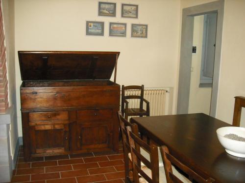 a dining room with a table and a wooden dresser at Agriturismo La Scarpaia in Anghiari
