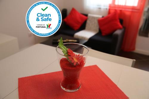 a drink sitting on a red napkin on a table at Casa Alegria by CosyCasa Praia Peniche in Peniche