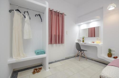 a white bathroom with a sink and a desk at Jardin De Castillo , Naxos Town in Naxos Chora